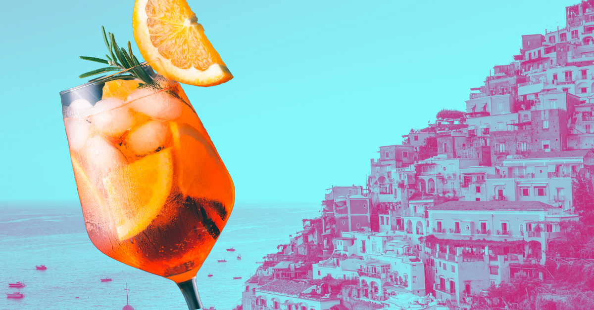 A European Vacation for the ages. Represented here by an aperol spritz against a backdrop of the Amalfi coast.